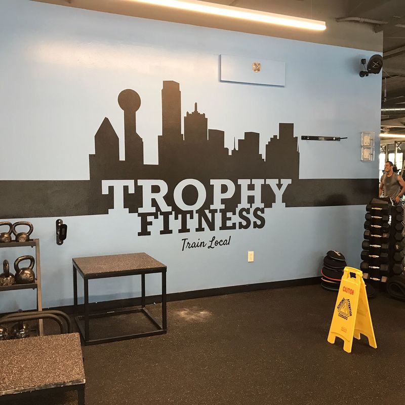 Client: Trophy Fitness Gym, Uptown Dallas, TX
Size: Approx. 12 feet W X 4 Ft. H
Scope: A Fitness gym located in Uptown needed artwork added  of their logo to a wall at the entrance to the fitness center.