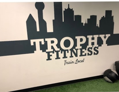 Client: Trophy Fitness 2, Gym, Downtown Dallas, TX
Size: Approx. 22 feet W X 4 Ft. H
Scope: A Fitness gym located in Downtown Dallas opened a 2nd location and needed artwork added  of their logo to a wall at the entrance to the fitness center. (closeup)