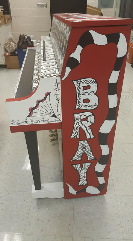 Client: Bray Elementary, CHISD, Cedar Hill, TX
Size: Piano and bench
Scope: This school was known in the district as the arts school and wanted their piano to be a functional centerpiece in the entrance of the campus. So they asked me to paint and decorate the piano in the color scheme of the district.