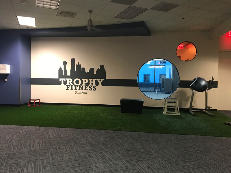 Client: Trophy Fitness 2, Gym, Downtown Dallas, TX
Size: Approx. 22 feet W X 4 Ft. H
Scope: A Fitness gym located in Downtown Dallas opened a 2nd location and needed artwork added  of their logo to a wall at the entrance to the fitness center.
